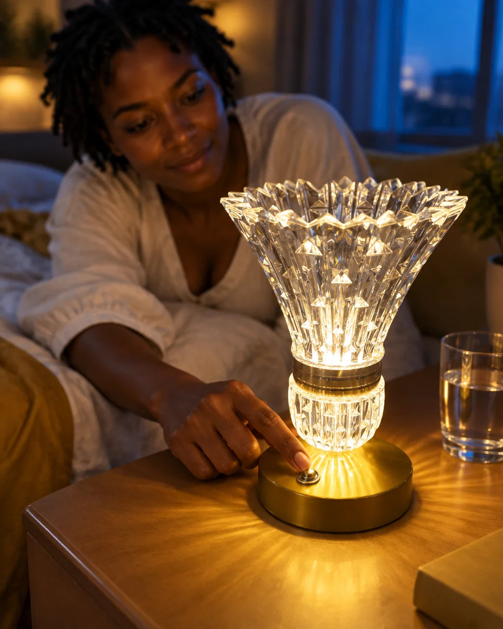 The Lampe Cristal Doré is the largest, sharpest subject: its exact faceted crystal body and golden b